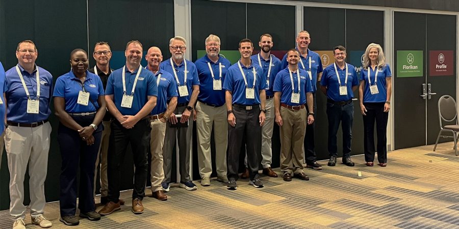 A group of Profile team members standing outside the the entrance to Cultivate 2024